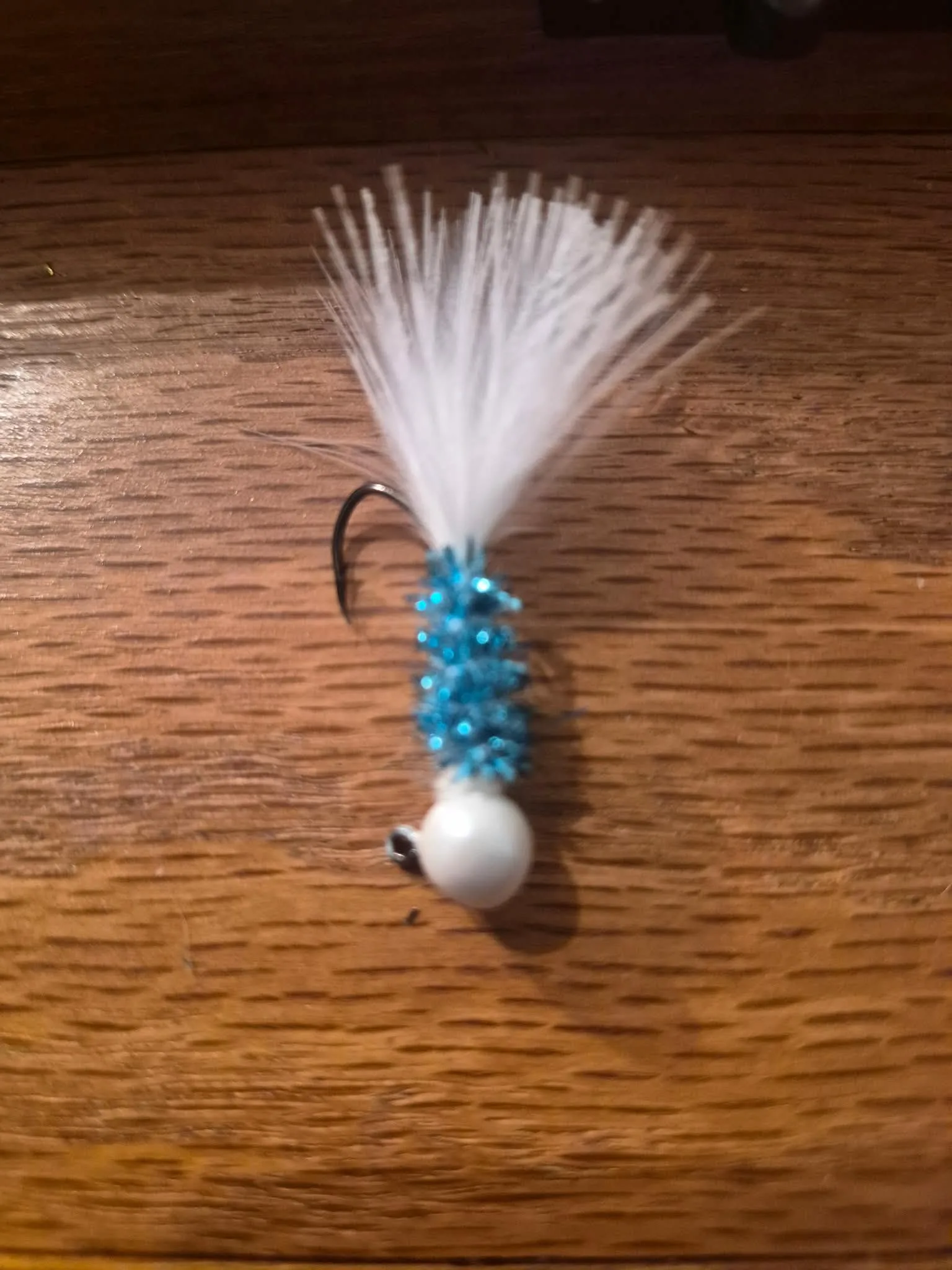 Snowflake jig — orange fishing lure with pink flash